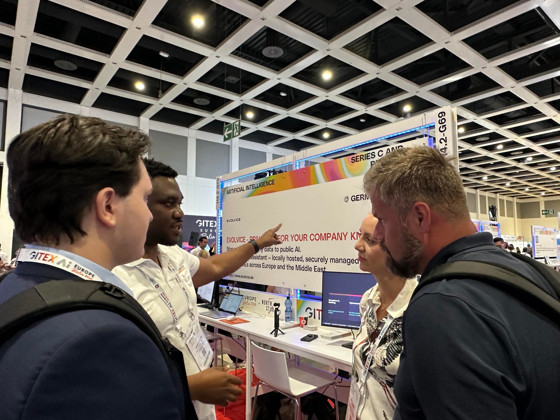 Evolvice team discussing Private AI Workspace with visitors