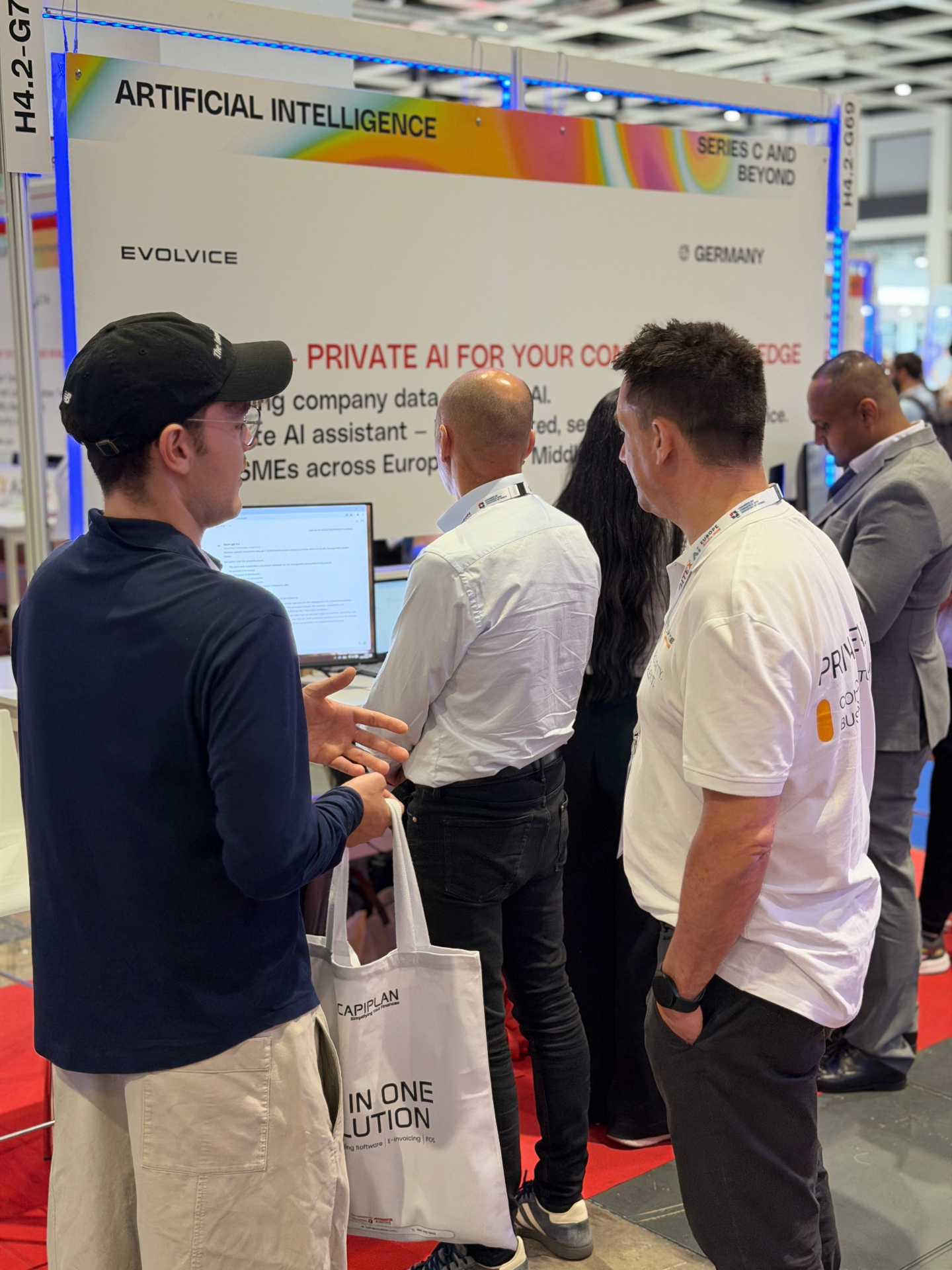 Visitors exploring the Private AI live demo at the Evolvice booth