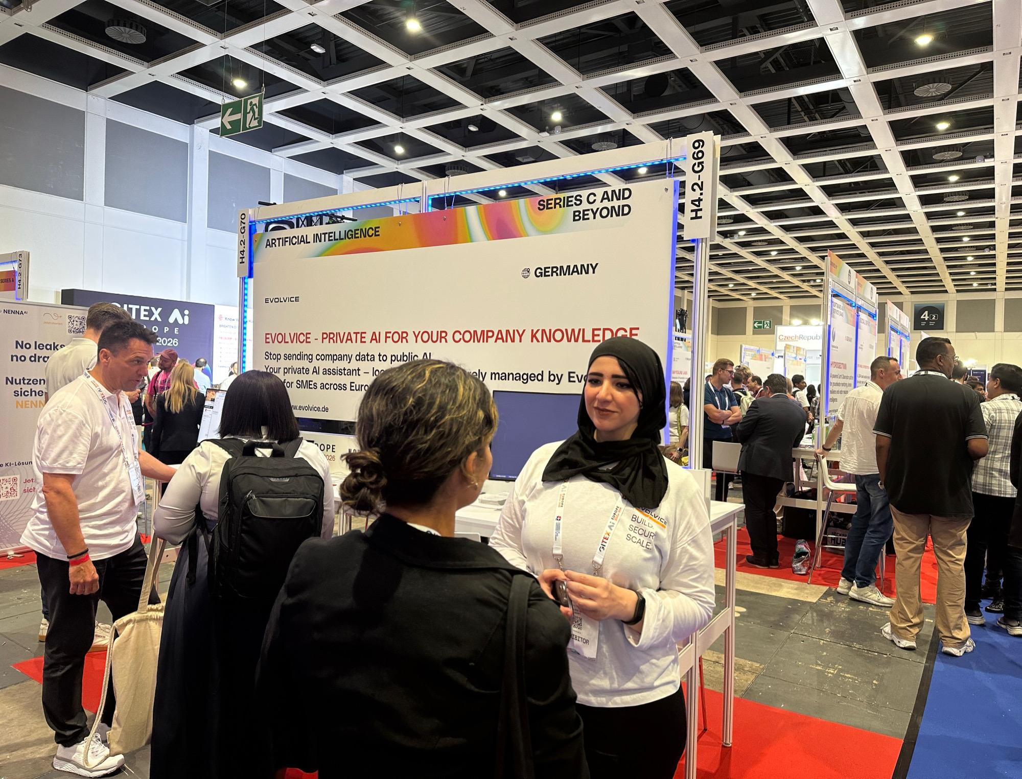 Evolvice team greeting visitors at Hall 4.2, booth H4.2-G69/G70