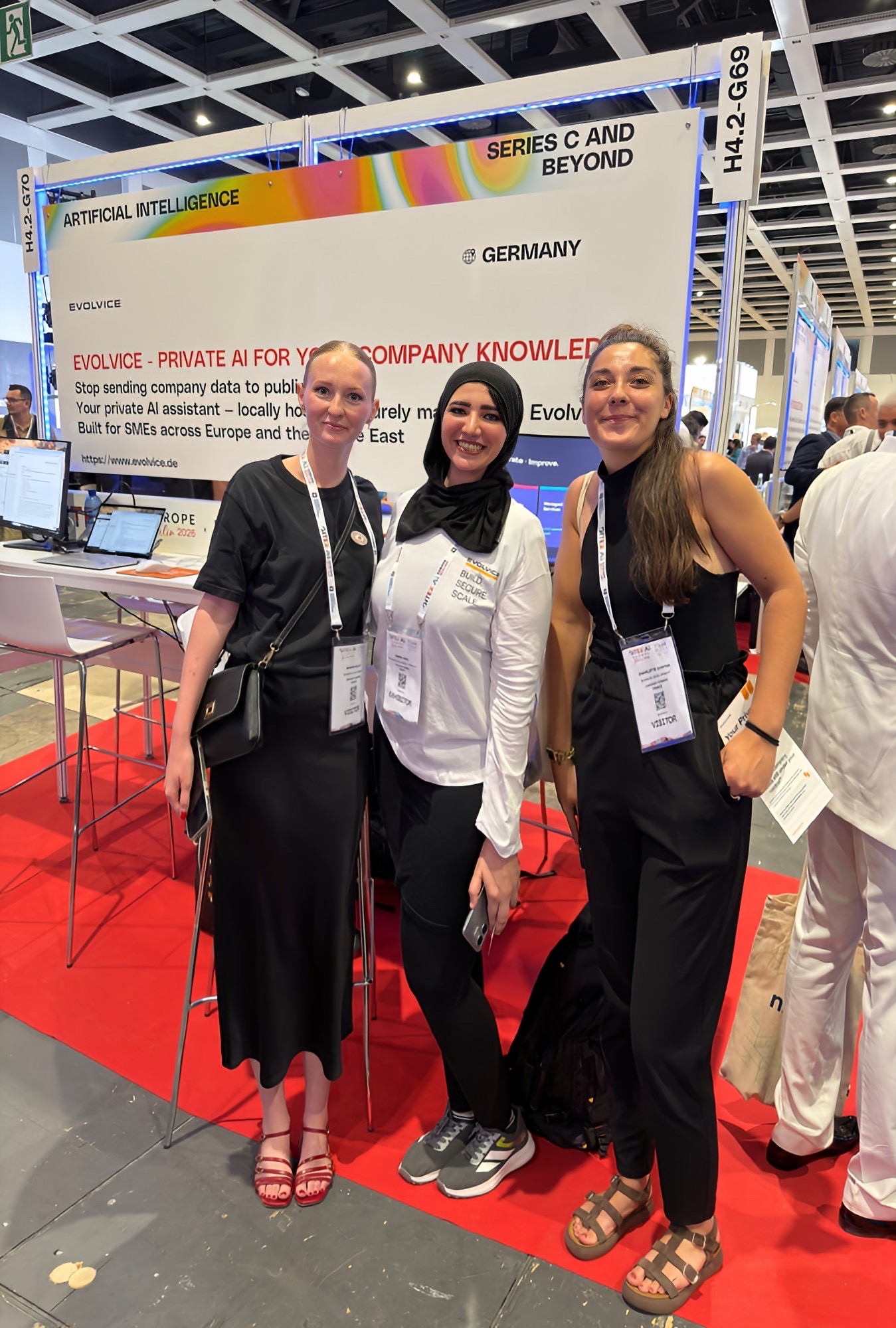 Evolvice team with international visitors at the booth